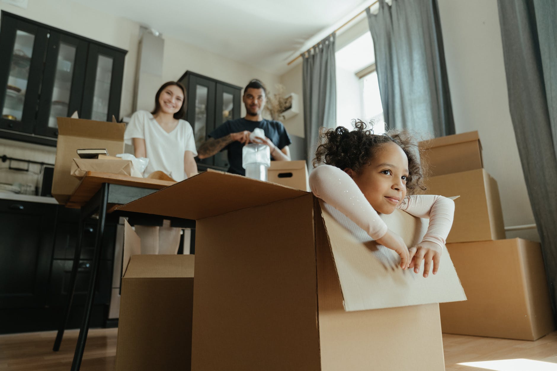little girl playing in a box - moving house planner