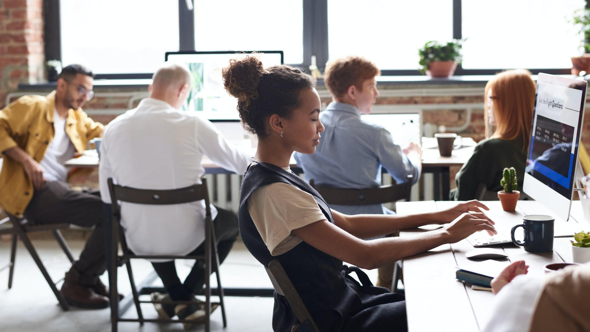 woman in white and black top using computer - new business premises