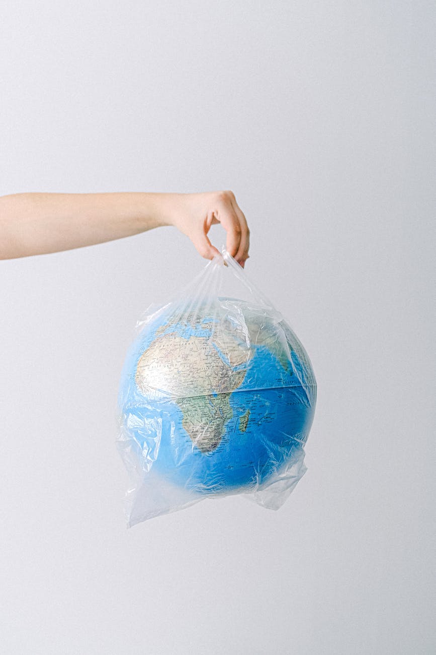 a person holding a plastic bag with a globe