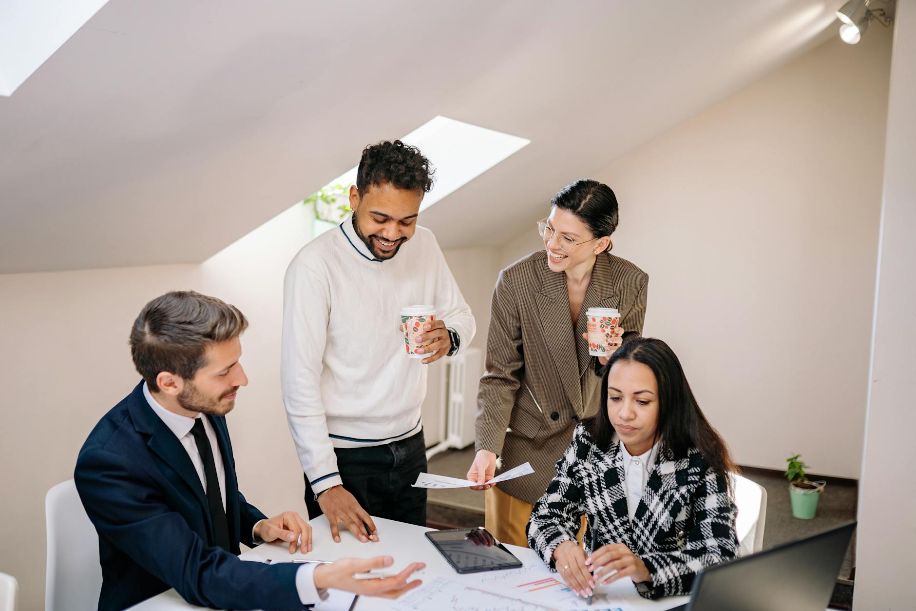 smiling colleagues araound table at office