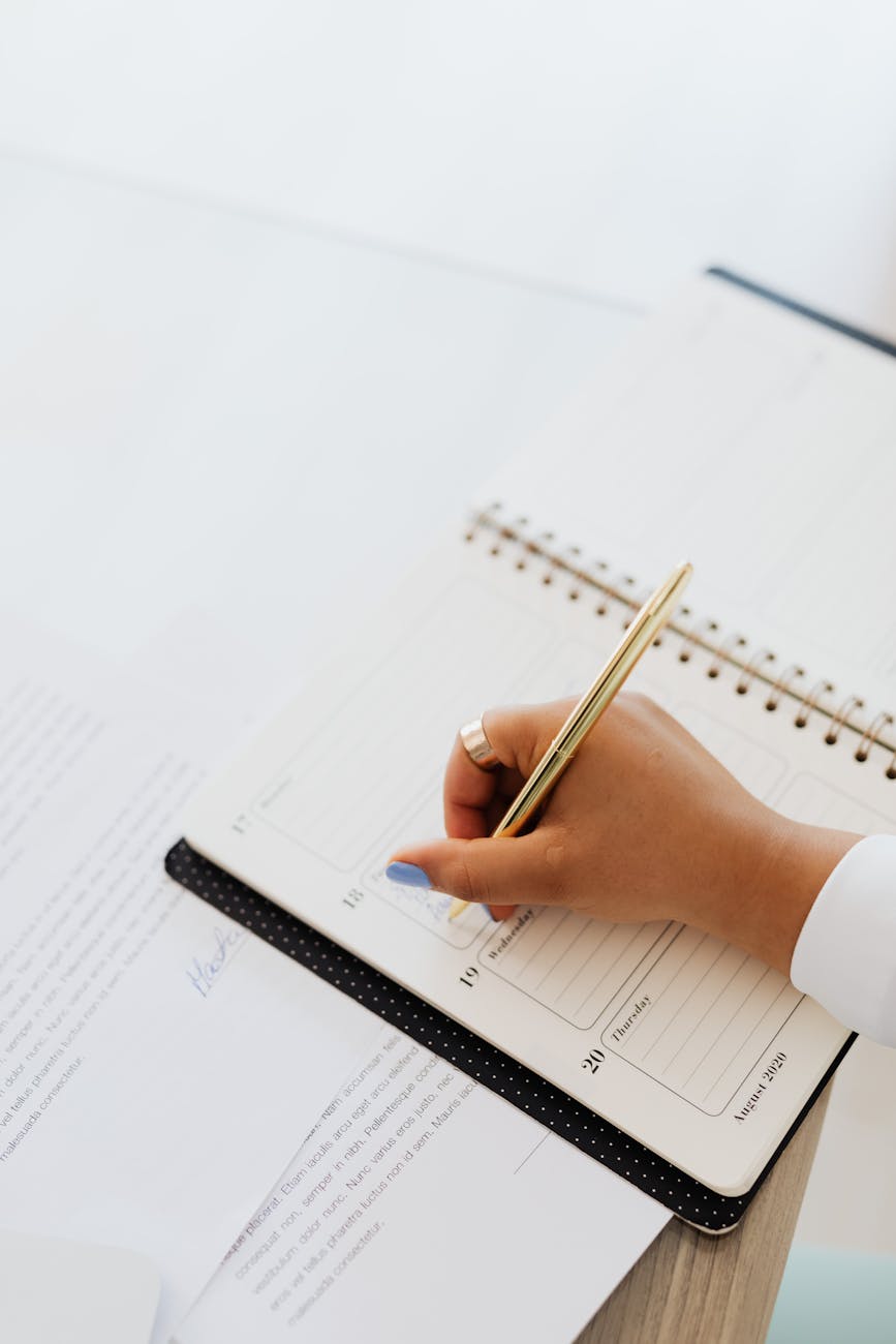 close up view of a person writing on notebook