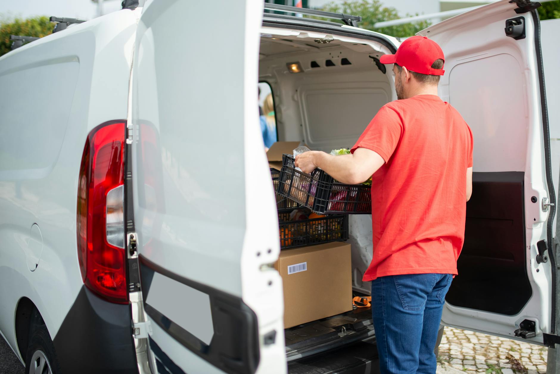 a man putting basket in a van