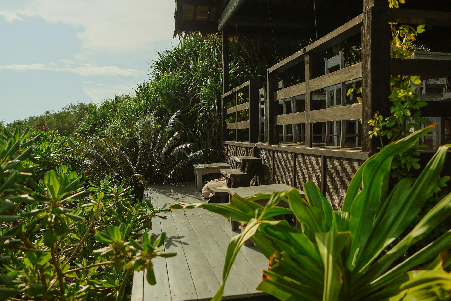 tropical outdoor deck surrounded by lush greenery