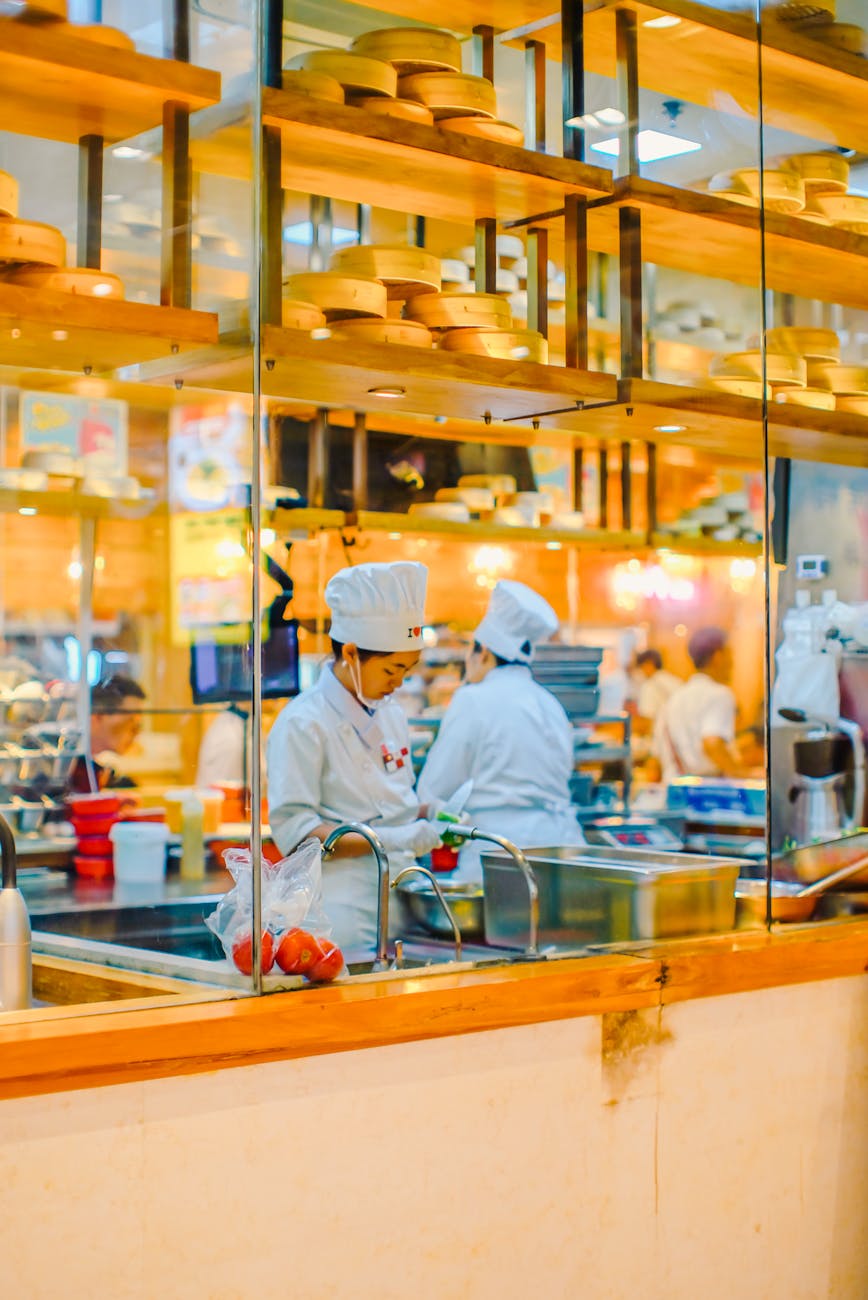 chefs preparing meals in chinese restaurant kitchen
