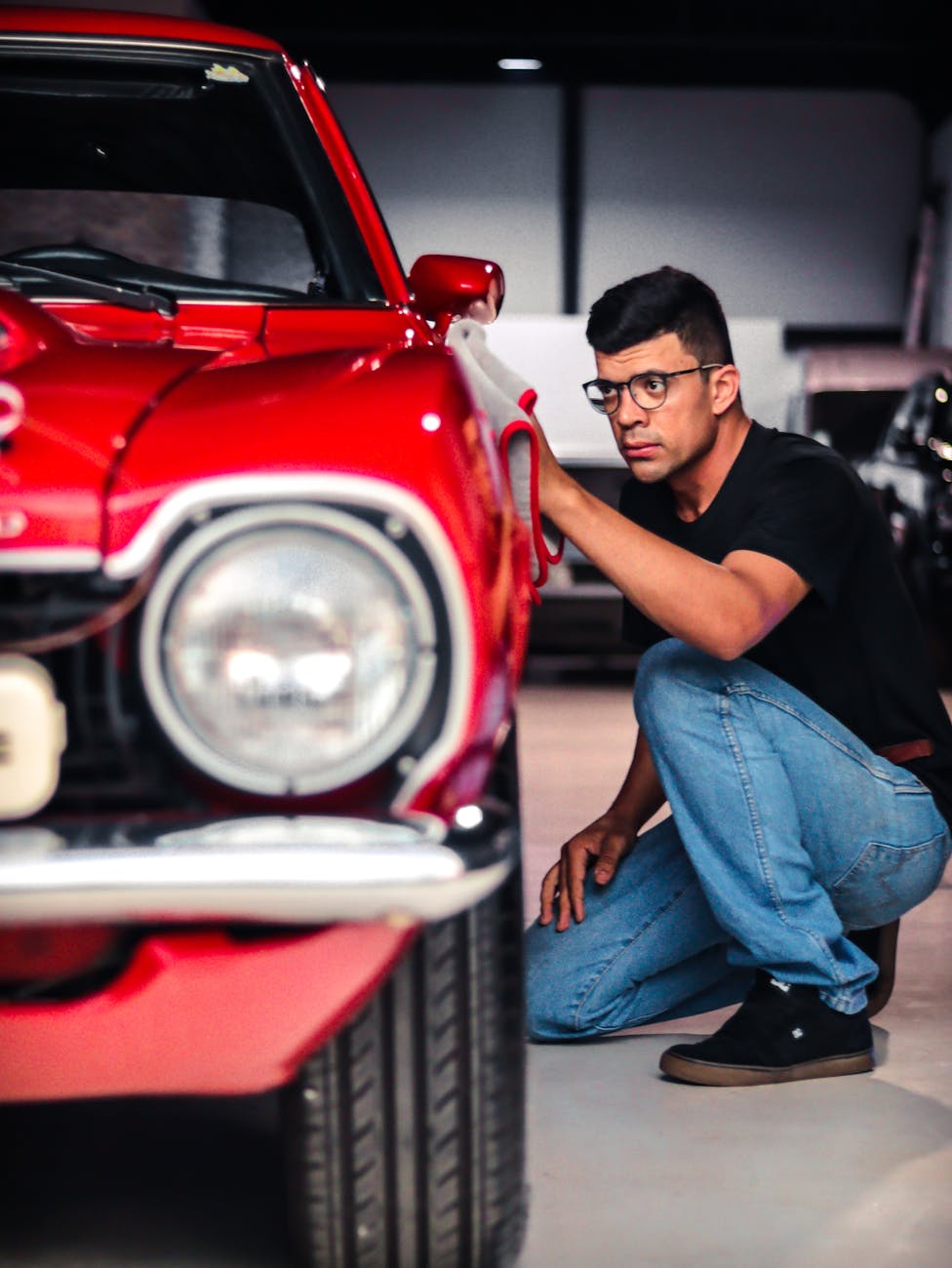 man looking at a vintage car