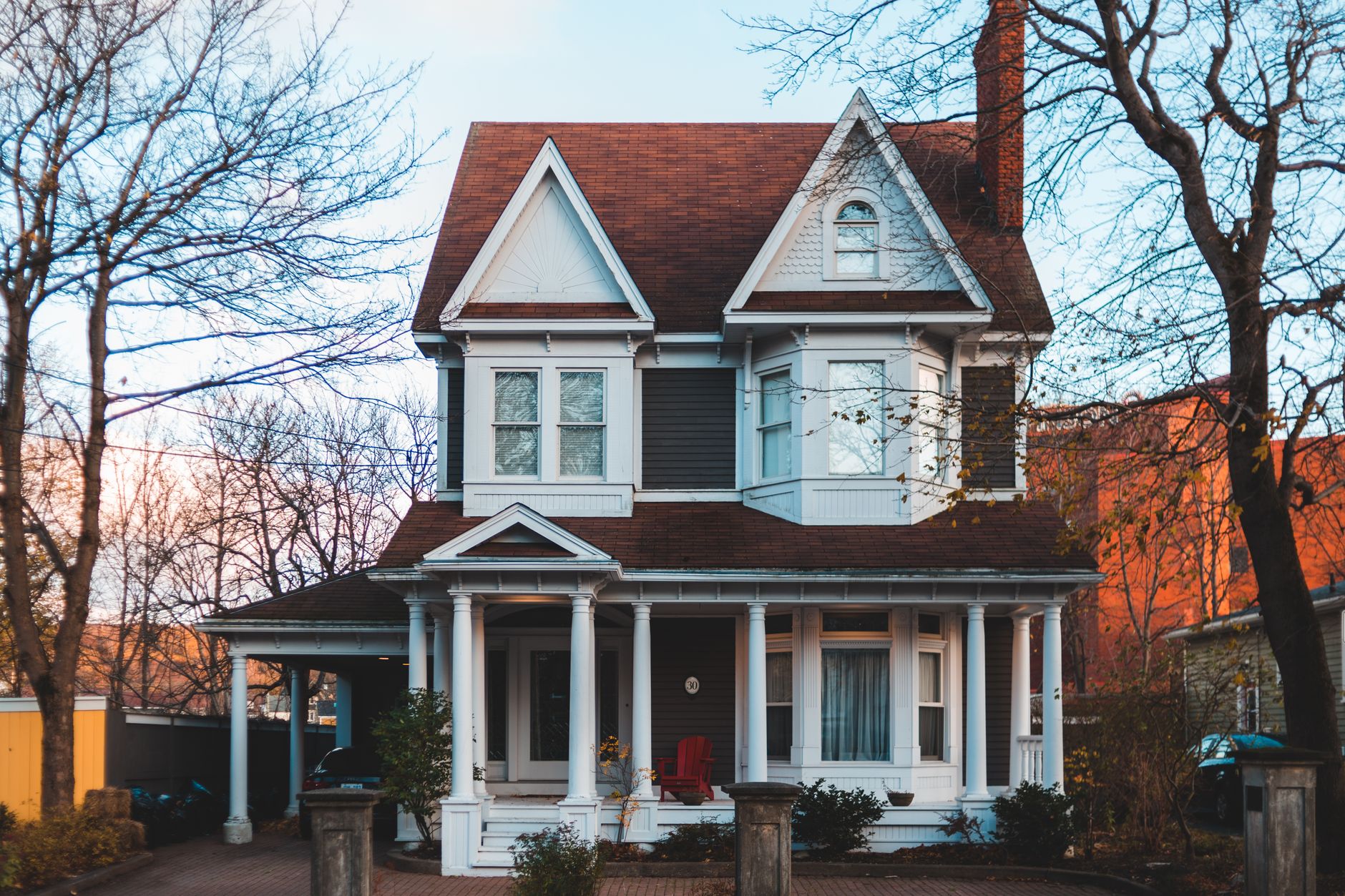 brown and white wooden house near bare trees