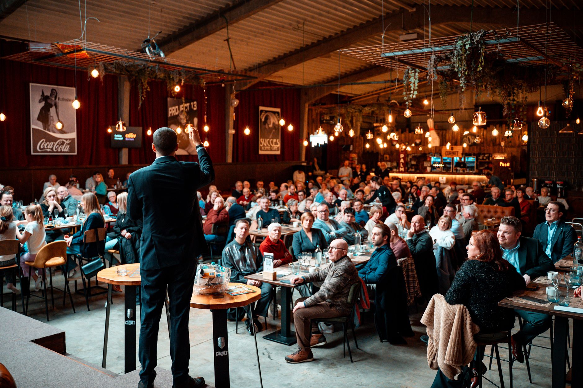 speaker engaging audience in packed venue